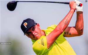 Rickie Fowler takes a swing, seen supporting Olympic rings tattoo